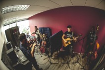 Group of Art of Songwriting students recording their works in the studio